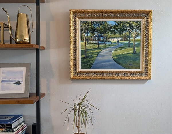 Framed painting on the wall near a bookshelf