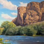 Painting of a river with desert mountains