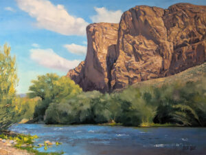 Painting of a river with desert mountains